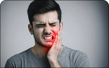 Man holding his cheek in discomfort due to a severe toothache.