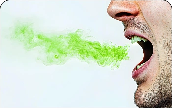 Man covering his mouth with his hand, illustrating concerns with bad breath (halitosis)